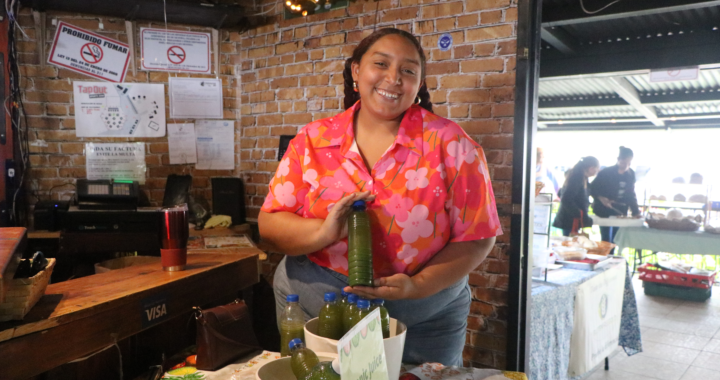 Smiling lady from Boquete holding a healthy juice